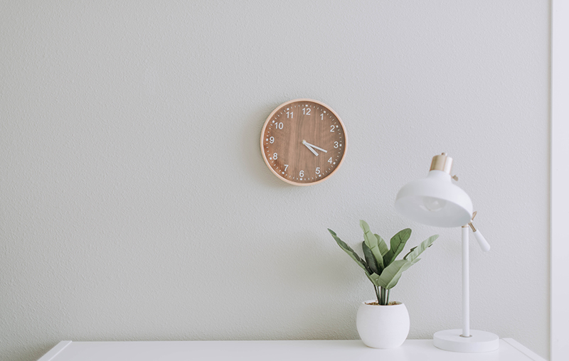 a room with table, clock and lamp